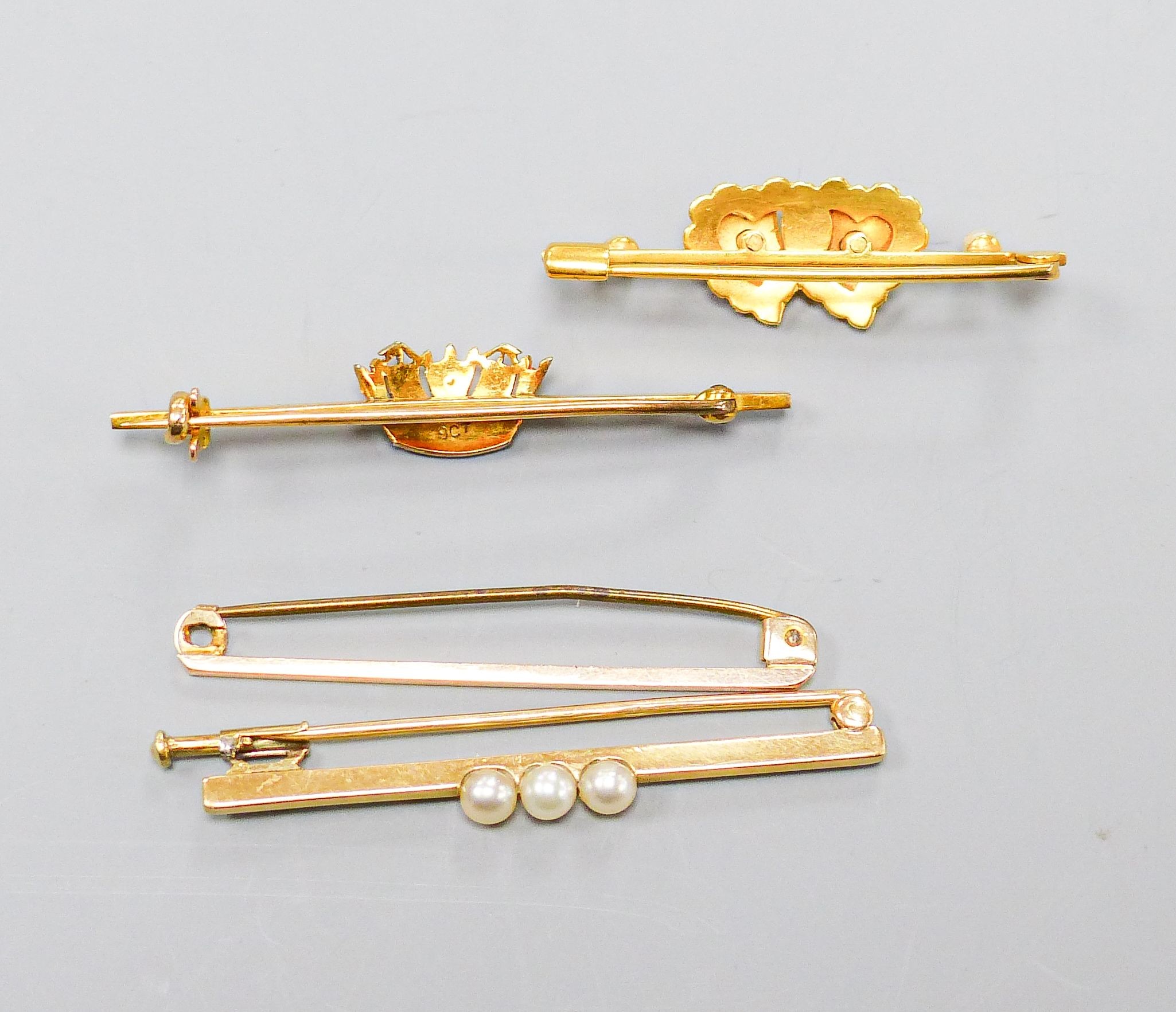 Four 9ct gold bar brooches, three set with seed pearls, largest 47mm, gross 10.4 grams.